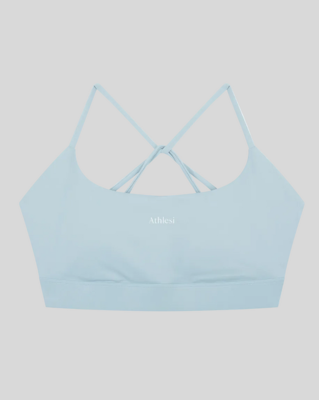 CoreLine Studio Sports Bra in light blue, flatlay front view with scoop neckline