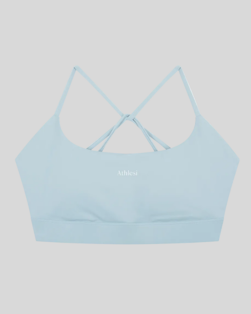 CoreLine Studio Sports Bra in light blue, flatlay front view with scoop neckline