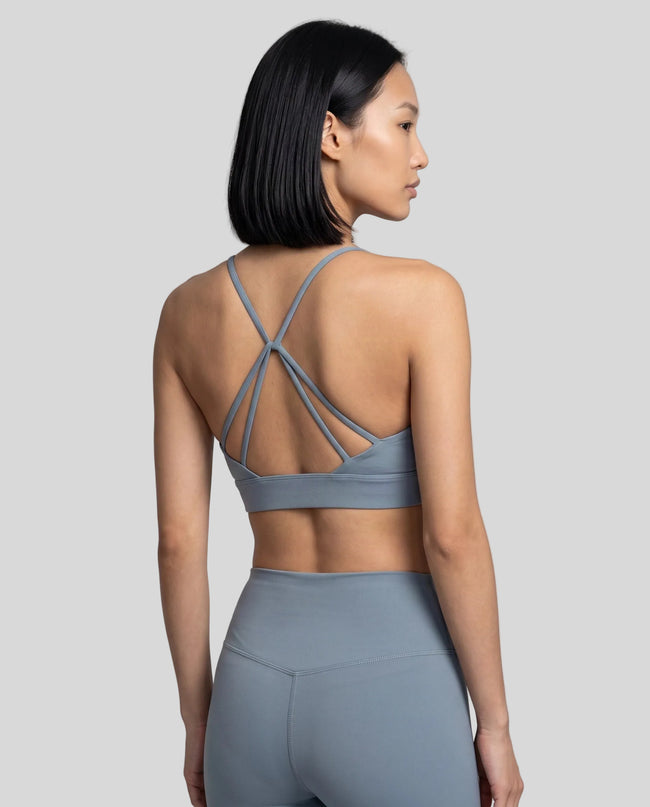CoreLine Studio Sports Bra in light blue, upper body angled back view