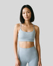 CoreLine Studio Sports Bra in light blue, front view styled on model