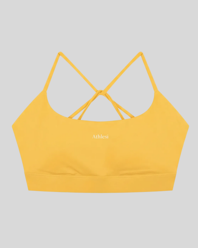 CoreLine Studio Sports Bra in yellow, flatlay front view with scoop neckline