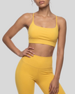 CoreLine Studio Sports Bra in yellow, angled front view showing fit