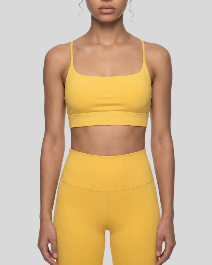 CoreLine Studio Sports Bra in yellow, mid body front view