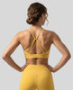 CoreLine Studio Sports Bra in yellow, back view styled on model with strappy detail