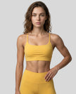 CoreLine Studio Sports Bra in yellow, front view styled on model