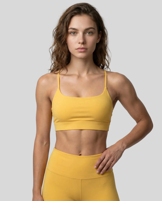 CoreLine Studio Sports Bra in yellow, front view styled on model