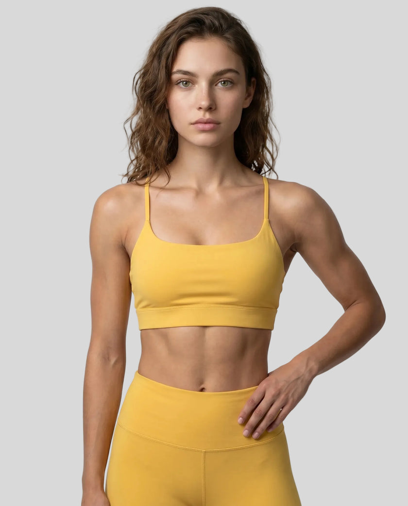 CoreLine Studio Sports Bra in yellow, front view styled on model
