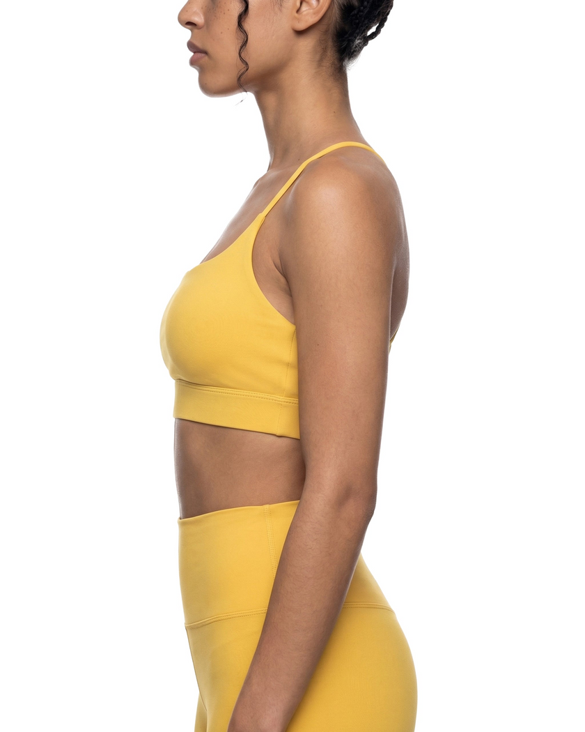 CoreLine Studio Sports Bra in yellow, side view highlighting straps