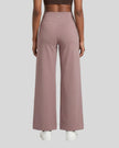 Back view of woman wearing Cameo CoreLine Yoga Pants with a matching color sports bra.