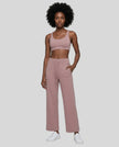 Model wearing CoreLine Yoga Pants in Cameo angled front view