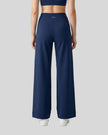 Model wearing CoreLine Yoga Pants in Navy Blue back view