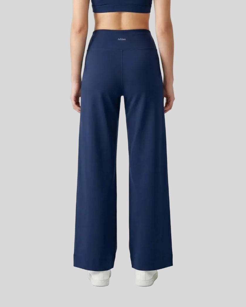 Model wearing CoreLine Yoga Pants in Navy Blue back view