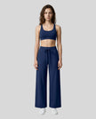 Front view of woman wearing Navy Blue CoreLine Yoga Pants with a matching color sports bra.