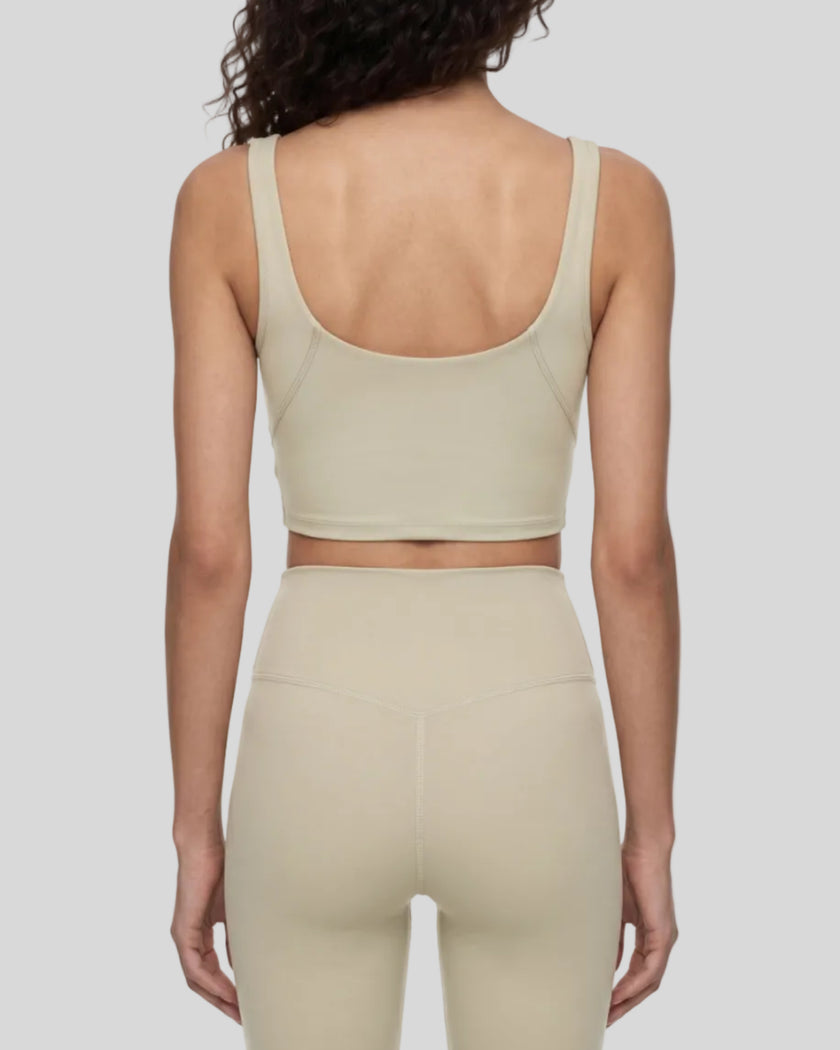 Model wearing CoreLine Yoga Sports Bra in Pale Khaki back view