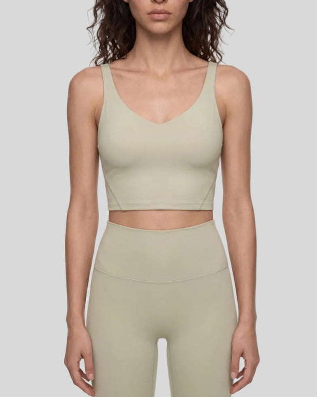 Model wearing CoreLine Yoga Sports Bra in Pale Khaki front view