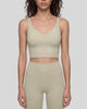Model wearing CoreLine Yoga Sports Bra in Pale Khaki front view