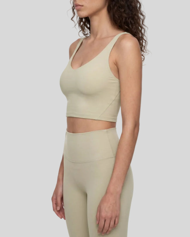 Model wearing CoreLine Yoga Sports Bra in Pale Khaki side view