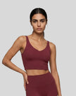 Model wearing CoreLine Yoga Sports Bra in Wine Red front angle view