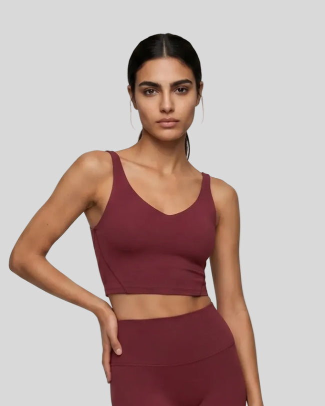 Model wearing CoreLine Yoga Sports Bra in Wine Red front angle view