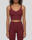 Model wearing CoreLine Yoga Sports Bra in Wine Red front view