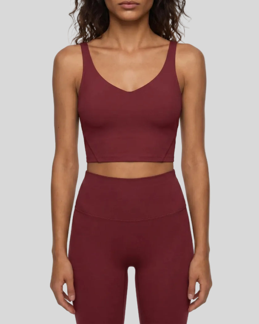 Model wearing CoreLine Yoga Sports Bra in Wine Red front view