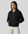 CoreZip Hooded Jacket in black worn by model mid body front view highlighting fit and structure