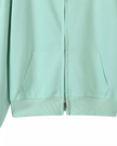 CoreZip Hooded Jacket in light green close-up showing front zipper detail