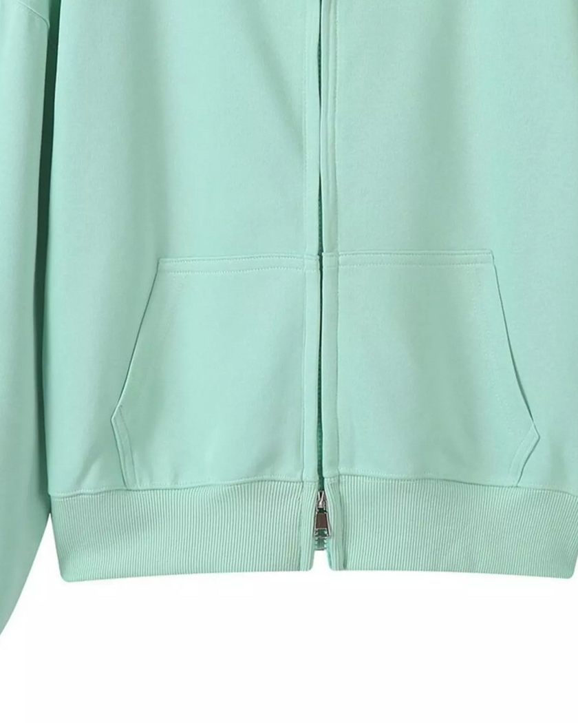 CoreZip Hooded Jacket in light green close-up showing front zipper detail