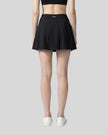 Back view of a model wearing the CourtClub A-Line Skirt in Black