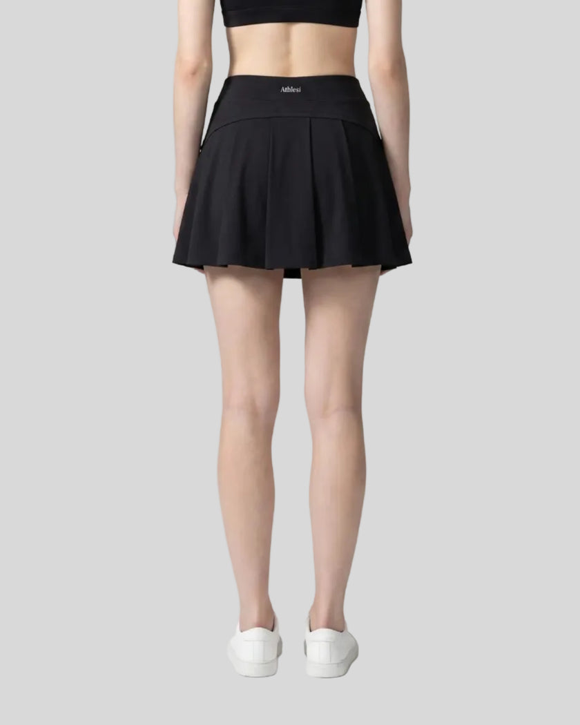 Back view of a model wearing the CourtClub A-Line Skirt in Black