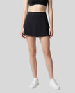 Model wearing the CourtClub A-Line Skirt in Black viewed from the front