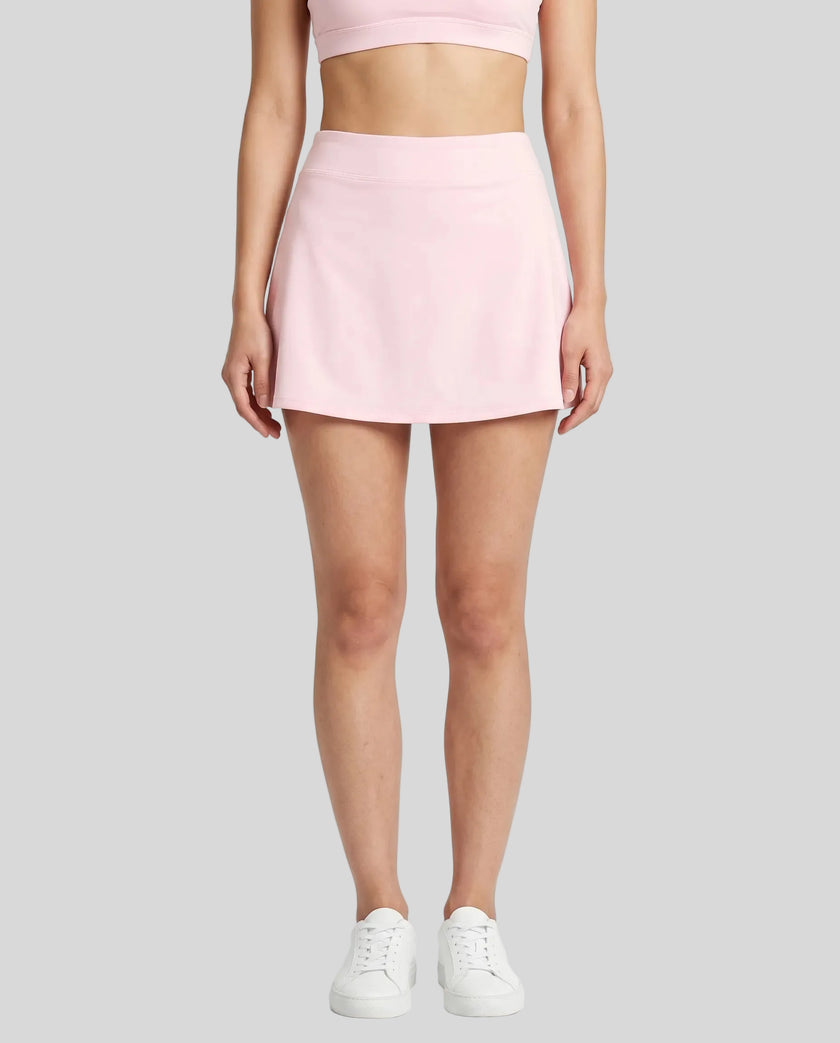 Model wearing the CourtClub A-Line Skirt in Light Pink viewed from the front