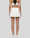 Back view of a model wearing the CourtClub A-Line Skirt in White