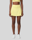 Model wearing the CourtClub A-Line Skirt in Yellow viewed from the front