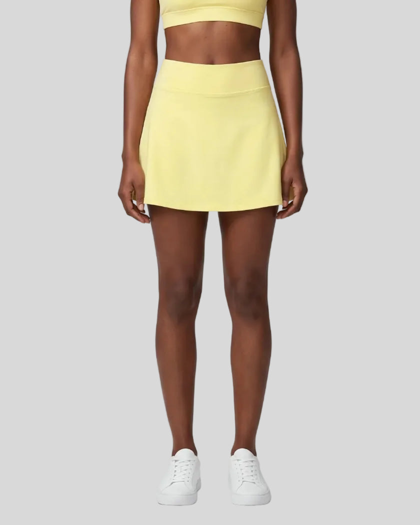 Model wearing the CourtClub A-Line Skirt in Yellow viewed from the front