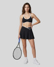 Model wearing the CourtClub Color Block A-Line Skirt in Black, full body front view