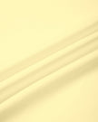 Close-up of the smooth stretch fabric used in the CourtClub Color Block A-Line Skirt in Light Yellow