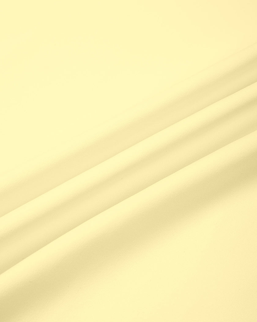 Close-up of the smooth stretch fabric used in the CourtClub Color Block A-Line Skirt in Light Yellow