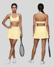 Front and Back view of a model wearing the CourtClub Color Block A-Line Skirt in Light Yellow