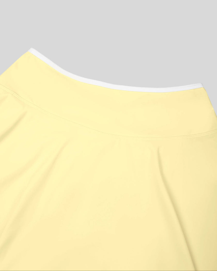 Close-up of the back waistband on the CourtClub Color Block A-Line Skirt in Light Yellow