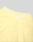 Close-up of the crossover waistband and contrast trim on the CourtClub Color Block A-Line Skirt in Light Yellow