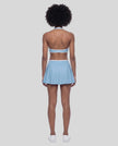 Back view of a model wearing the CourtClub Color Block A-Line Skirt in Sky Blue