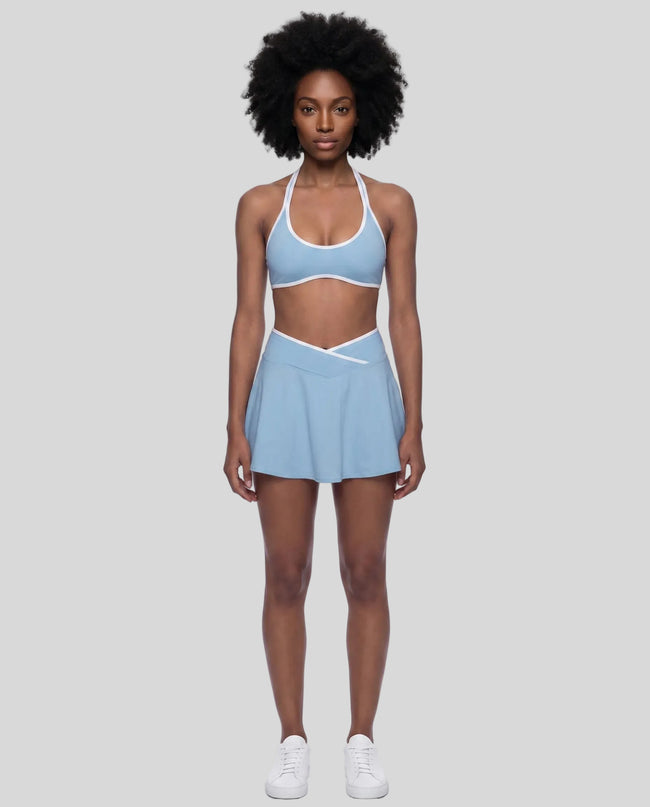 Model wearing the CourtClub Color Block A-Line Skirt in Sky Blue, lower body front view