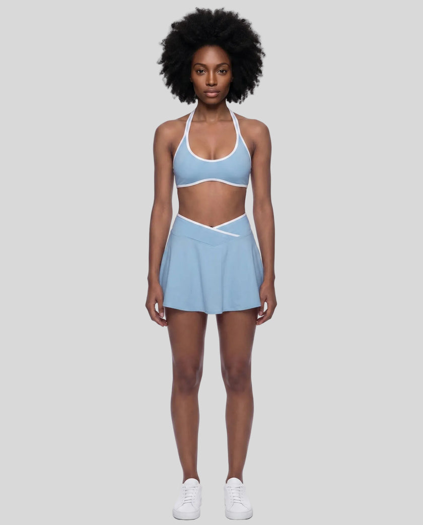 Model wearing the CourtClub Color Block A-Line Skirt in Sky Blue, lower body front view