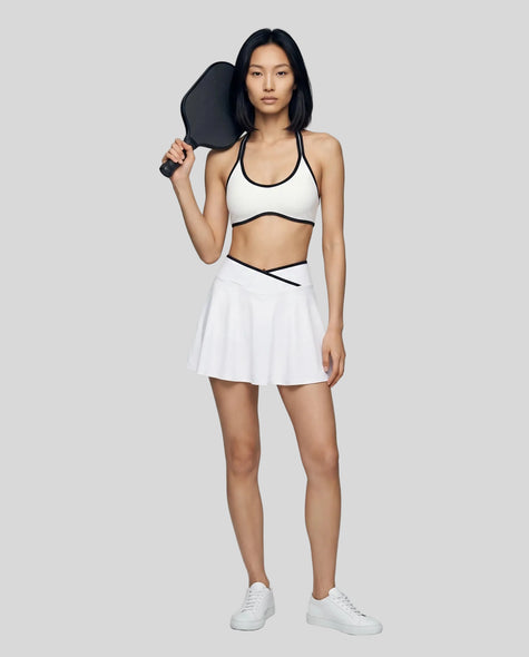 Model wearing the CourtClub Color Block A-Line Skirt in White, full body front view