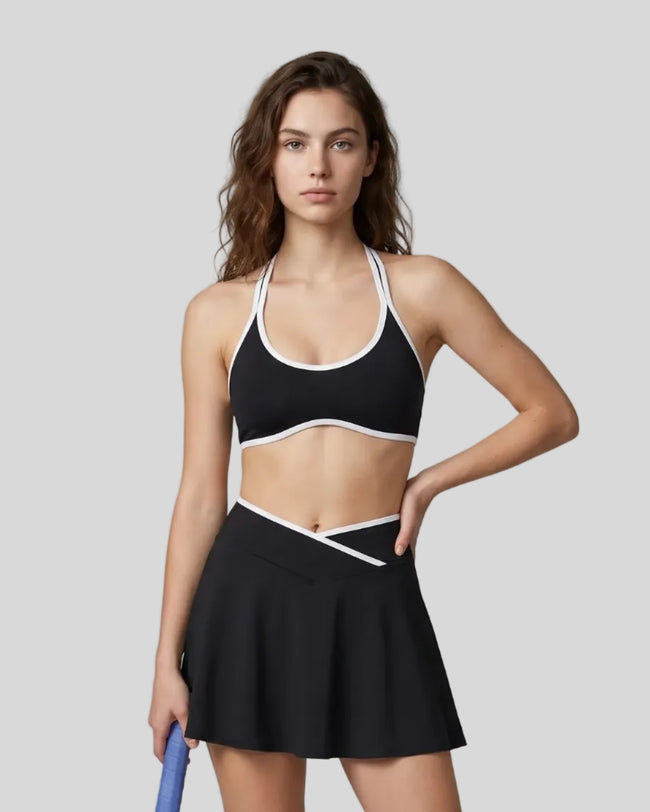 Model wearing the CourtClub Color Block Halter Sports Bra in Black viewed from the front