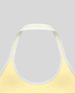 Close-up of the back halter construction and contrast trim on the CourtClub Color Block Halter Sports Bra in Light Yellow