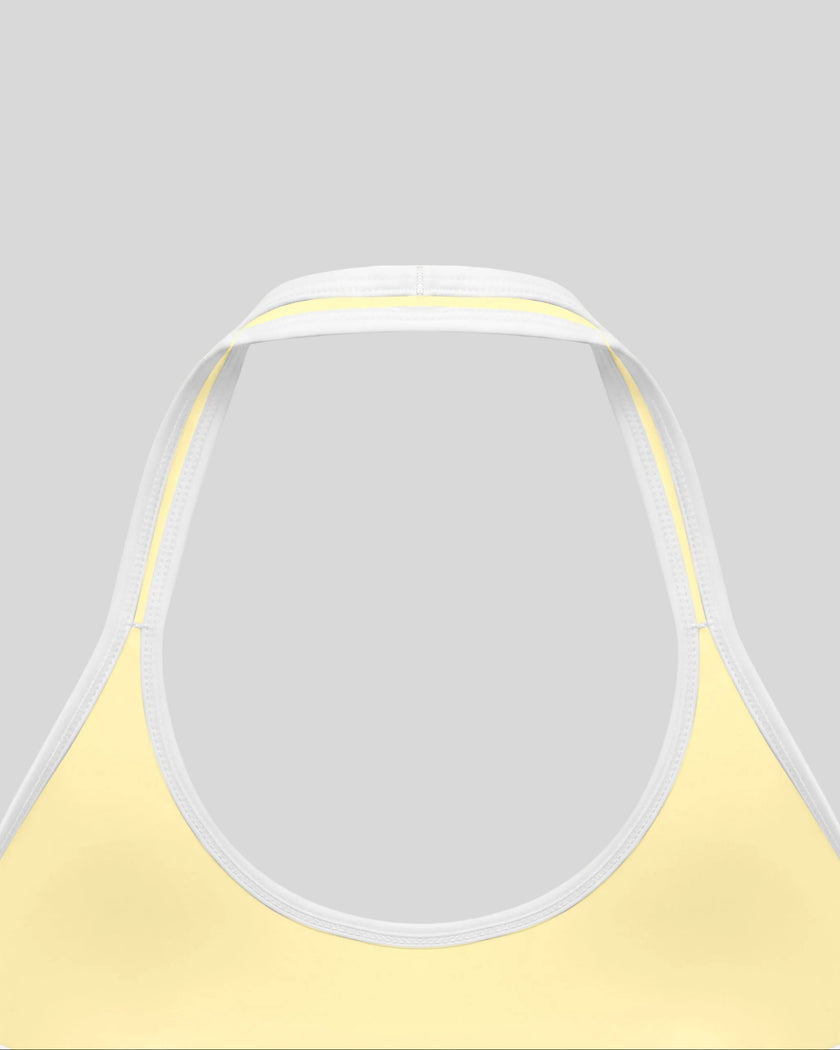 Close-up of the back halter construction and contrast trim on the CourtClub Color Block Halter Sports Bra in Light Yellow