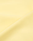 Detailed view of the soft stretch performance fabric used in the CourtClub Color Block Halter Sports Bra in Light Yellow
