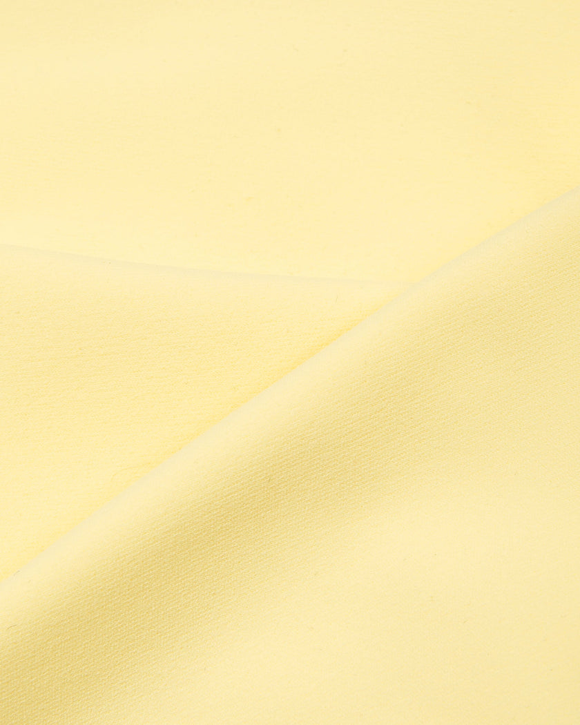 Detailed view of the soft stretch performance fabric used in the CourtClub Color Block Halter Sports Bra in Light Yellow